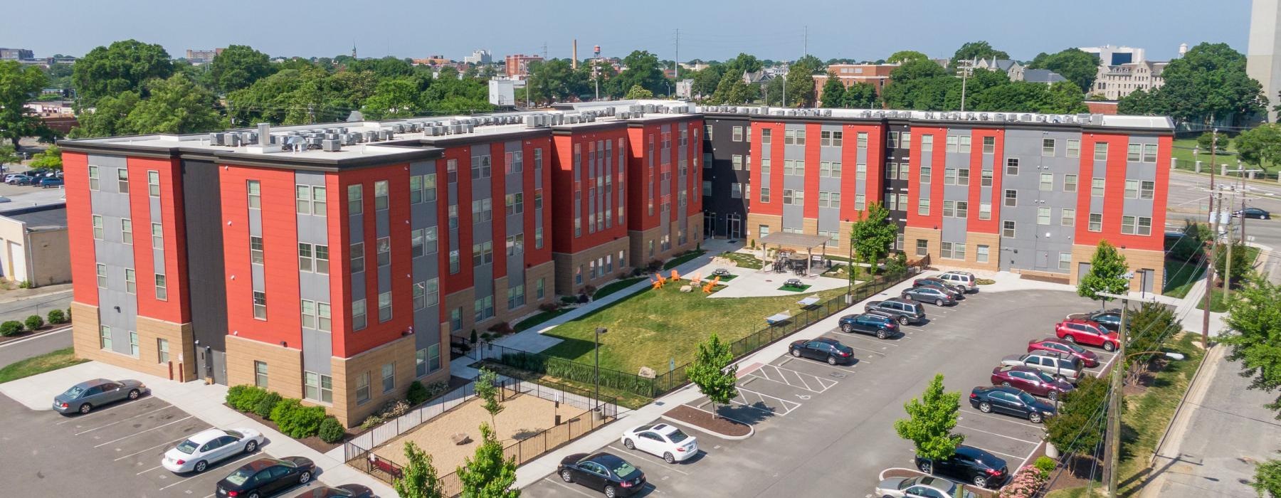 a parking lot with cars and buildings